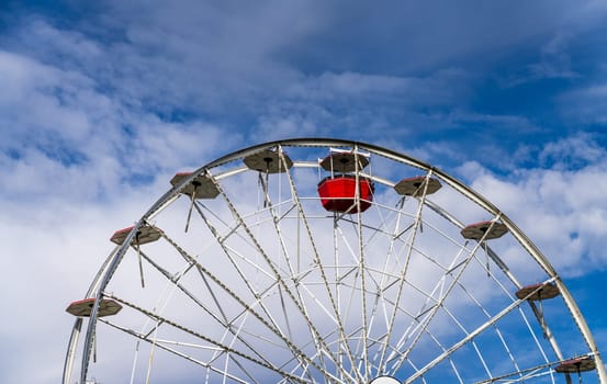 Single remaining carriage on large ferris wheel in amusement park in Davenport Iowa preparing for winter