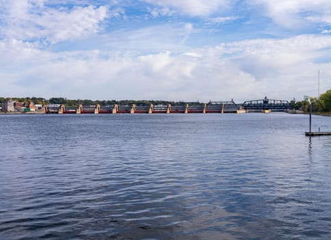 Lock and Dam across River Mississippi with Arsenal bridge behind in Davenport, Iowa seen from Illinois