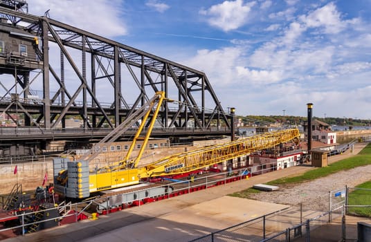 Davenport, IA - 18 October 2023: Army Corps of Engineers barge and crane enters Lock and Dam No. 15 in Davenport, Iowa