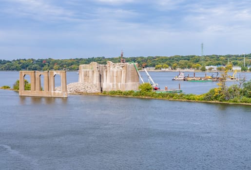 Heavy machinery removes the concrete pillars of historic I-74 bridge between Bettendorf Iowa and Moline Illinois