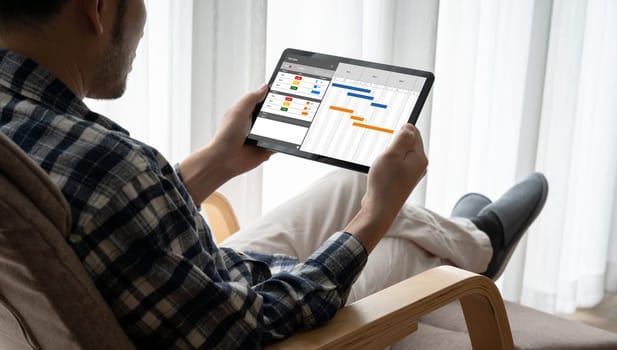 Project planning software for modish business project management on the computer screen showing timeline chart of the team project