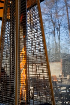 cafe terrace with tables and chairs with gas heater pyramid