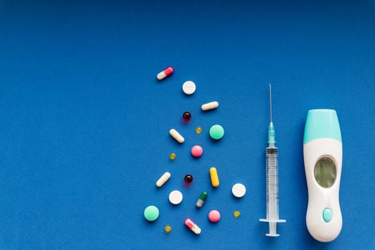 medicine next to a syringe. Medicines for the virus and flu. Medical pills and antibiotics. Coronavirus.