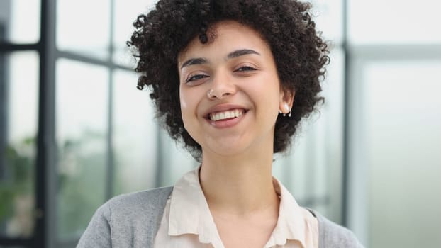 girl in the office smiles expresses success and leadership is thinking about success.