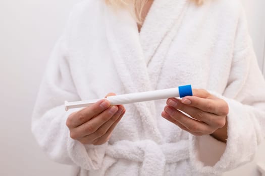 Woman Holds Pre-filled Applicator With Vaginal Antifungal Treatment Cream Or Gel. Caucasian Female Is Ready To Insert Tioconazole Remedy, Ointment Against Infections. Horizontal. High Quality Photo