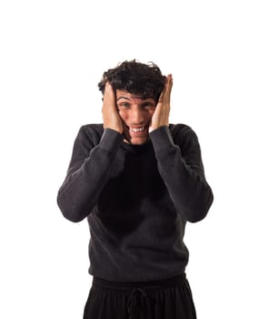 Young Man Forcing His Mouth To Smile By Pushing Lips and Cheeks With Hands in studio shot on white