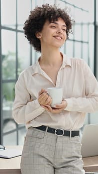 girl in the office smiles expresses success and leadership is thinking about success.