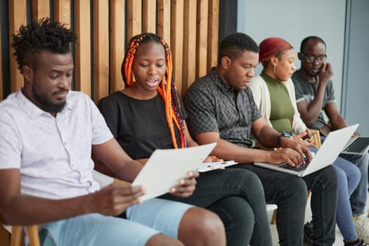 applicants sitting in queue and receiving recruitment files before job interview appointment.