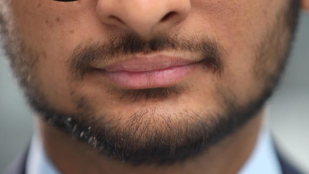 Close up cropped half face photo of stylish young man's bristle with thoughtful, minded expression