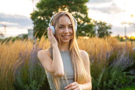 A happy lady takes pleasure in nature as she rests and enjoys her music