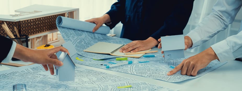 Worker, architect and engineer work on real estate construction project oratory planning with cartography and cadastral map of urban town area to guide to construction developer business plan of city