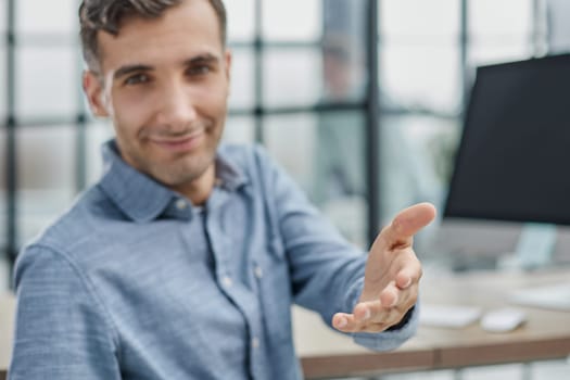 Young businessman holding handshaking after good deal