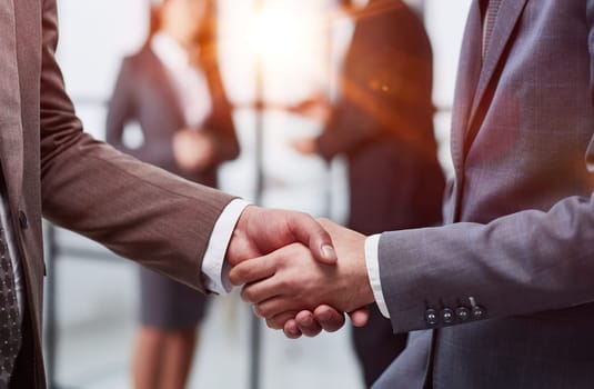 Nice to meet you. Close-up of two young businessmen shaking hands