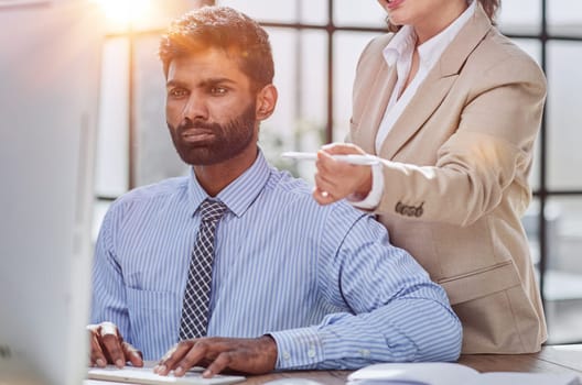 Group of business people and software developers working as a team in office