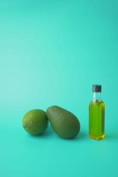 oil and slice of avocado on wooden table .