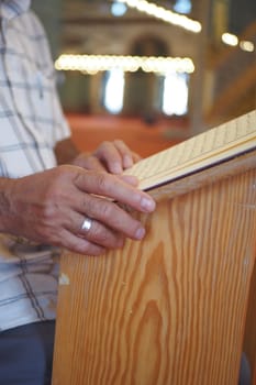 muslim man hand holding Holy book Quran at mosque .