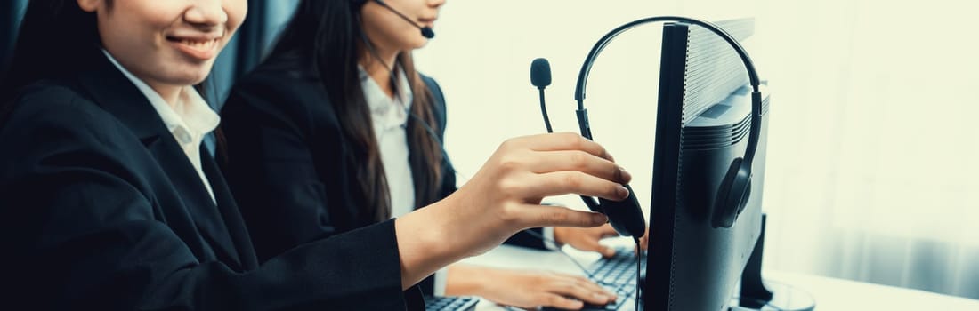 Business people wearing headset working in office to support remote customer or colleague. Call center, telemarketing, customer support agent provide service on telephone video conference oratory call