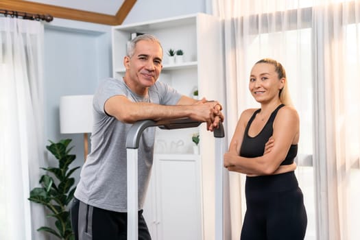 Athletic and sporty senior couple portrait in sportswear with standing posture as home exercise concept. Healthy fit body lifestyle after retirement. Clout