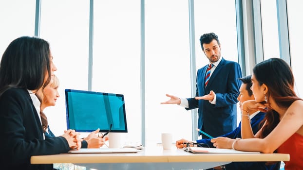 Business people in the conference room with green screen chroma key TV or computer on the office table. Diverse group of businessman and businesswoman in meeting on video conference call . Jivy