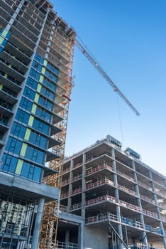 High-rise buildings under construction on blue sky background