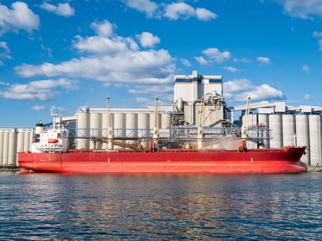 Dry-cargo ship moored at marine terminal for loading