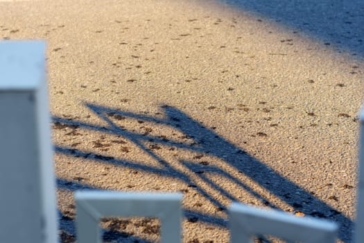 A shadow of a person standing on a sidewalk
