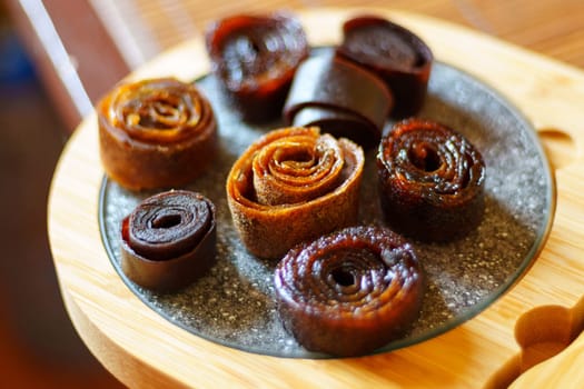 Fruit pastille, sweet fruits, dried fruits and berries. Raw food, vegan sweetness, dessert. Selective focus