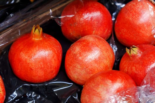 Fresh pomegranate fruit in refrigirator at food supermarket store. Natural healthy eating.