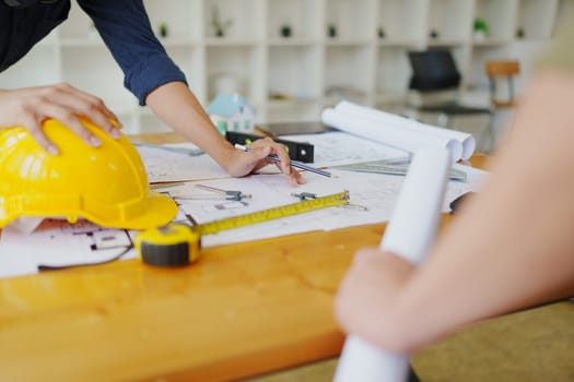 engineers discuss building on blueprint drawing, design building Project in office