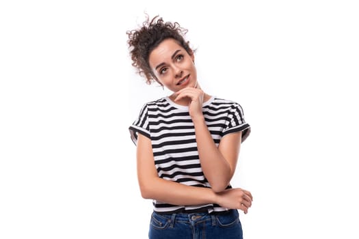 young caucasian woman with curly hair dressed in a striped summer t-shirt is brainstorming.