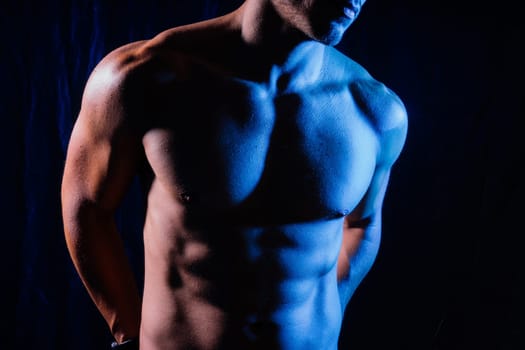 Beautiful male torso, muscular bodybuilder posing. Seductive portrait of a sport man.