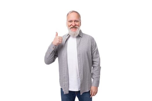 handsome mature man with white beard and mustache dressed in casual comfortable shirt and t-shirt.