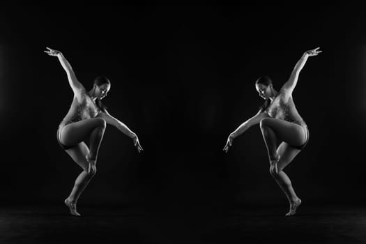 Ballet dancer in a black body paint isolated on studio background expressive artistic dance concept