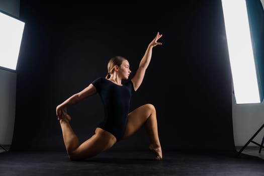 Ballet dancer in a black body paint isolated on studio background expressive artistic dance concept