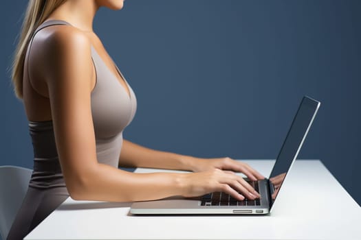 Business woman in light clothes typing on a laptop at the workplace. Woman working on a keyboard in the office.
