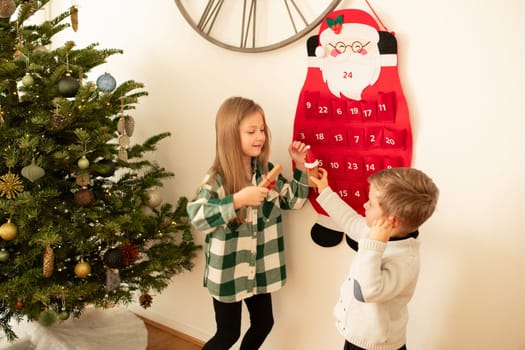 The brother and sister found gifts in Felt santa claus advent calendar