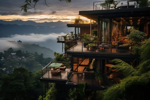 Modern villa in the mountains with stunning sunset views. Sun rays and fog. Observation deck of a luxury hotel.