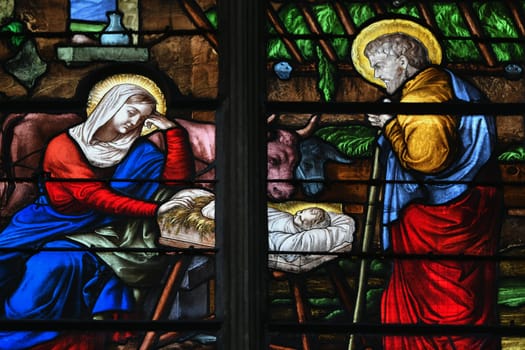 Stained glass with a scene of the birth of Jesus Christ in a church