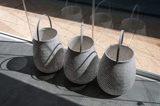 decorative gray baskets in a store on a counter near the window. High quality photo