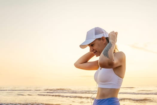 a sports girl stands against the background of the sea in sportswear, there is a place for an inscription. High quality photo