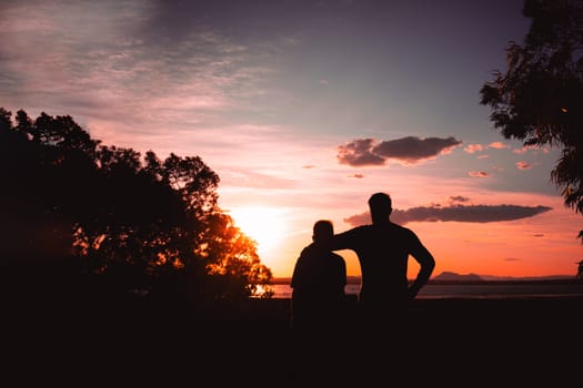 Father and son playing in the park at the sunset time. People having fun on the field. Concept of friendly family and of summer vacation. High quality photo