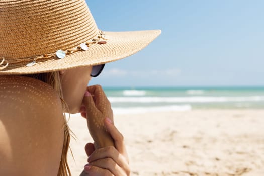 girl in a swimsuit on the seashore with glasses, there is a place for an inscription. High quality photo