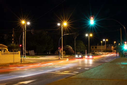 street in the city with cars at traffic lights, night city with traffic lights. High quality photo