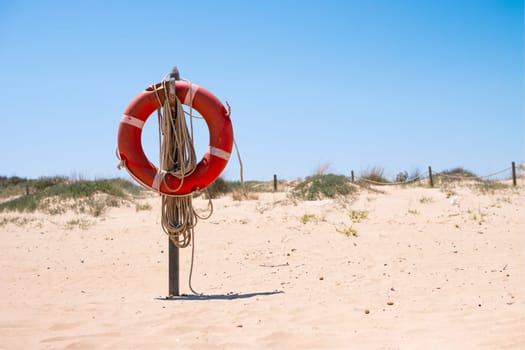 orange lifebuoy on the seashore, close-up.lifebuoy on the beach in the sand High quality photo