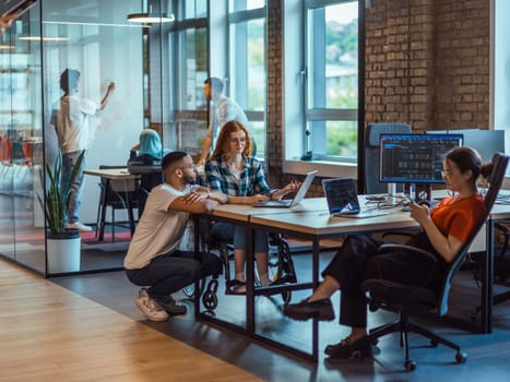 A diverse group of young business individuals congregates in a modern startup coworking center, embodying collaborative innovation and a dynamic atmosphere.