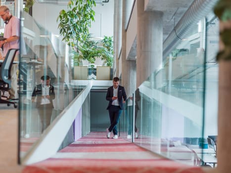 In a sleek corporate setting, the young and charismatic director strides confidently down the hallway, symbolizing his dynamic leadership and the promise of continued success within the company he guides.