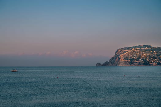 Beautiful sunrise scene on Alanya beach with view to famous Alanya island, in Turkey