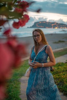 Woman sits on the beach and looks at the sea in Alanya city, Turkey. Travelling or vacation concept