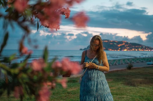 Woman sits on the beach and looks at the sea in Alanya city, Turkey. Travelling or vacation concept