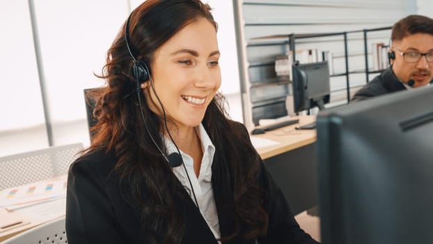 Business people wearing headset working in office to support remote customer or colleague. Call center, telemarketing, customer support agent provide service on telephone video conference call. Jivy